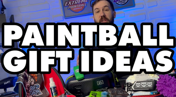 A picture of Sam with tons of items on the table and it reads Paintball Gift Ideas.