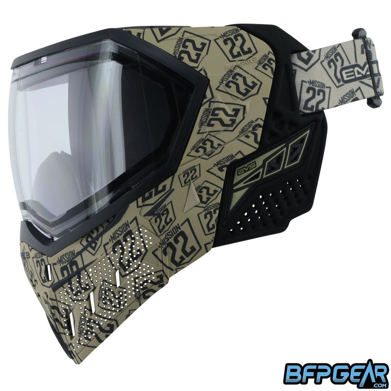 Mission 22 EVS facing to the left with the clear lens installed. The ears of the goggle are black and tan. The mission 22 strap is shown installed on the goggle and shares the same tan with black stamp pattern as the goggle.