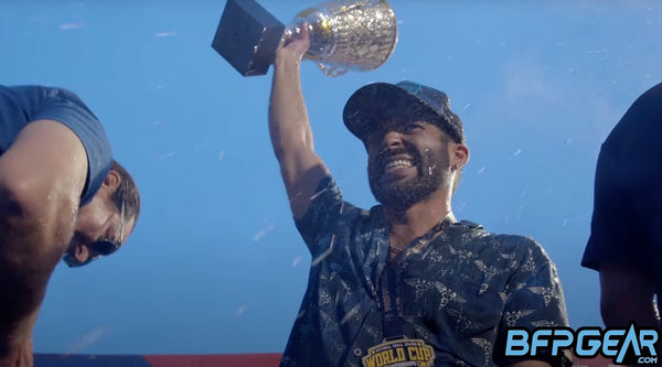 Archie Montemayor holding the World Cup trophy up high.