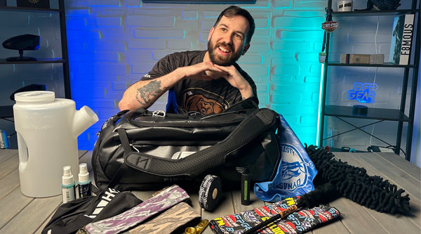 A photo of Sam with all of the essential items that should be in your gearbag.