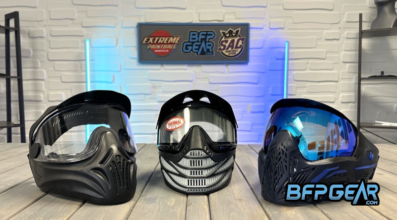 Pictured here are three sets of paintball goggles. From left to right: Empire Helix in black, JT ProFlex 8 in black and grey, and the Bunker Kings CMD goggle in Black Azure.