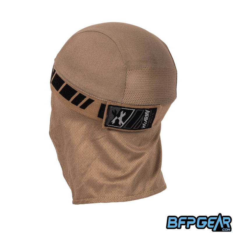 An angled view of the back of the skull cap in the Dune color way. The elastic band secures firmly with velcro, and shows off an HK Army tag on the back. The mesh lining goes from the apex of the back of your head down over your neck for the best ventilation. The retro pattern goes all around the elastic band.