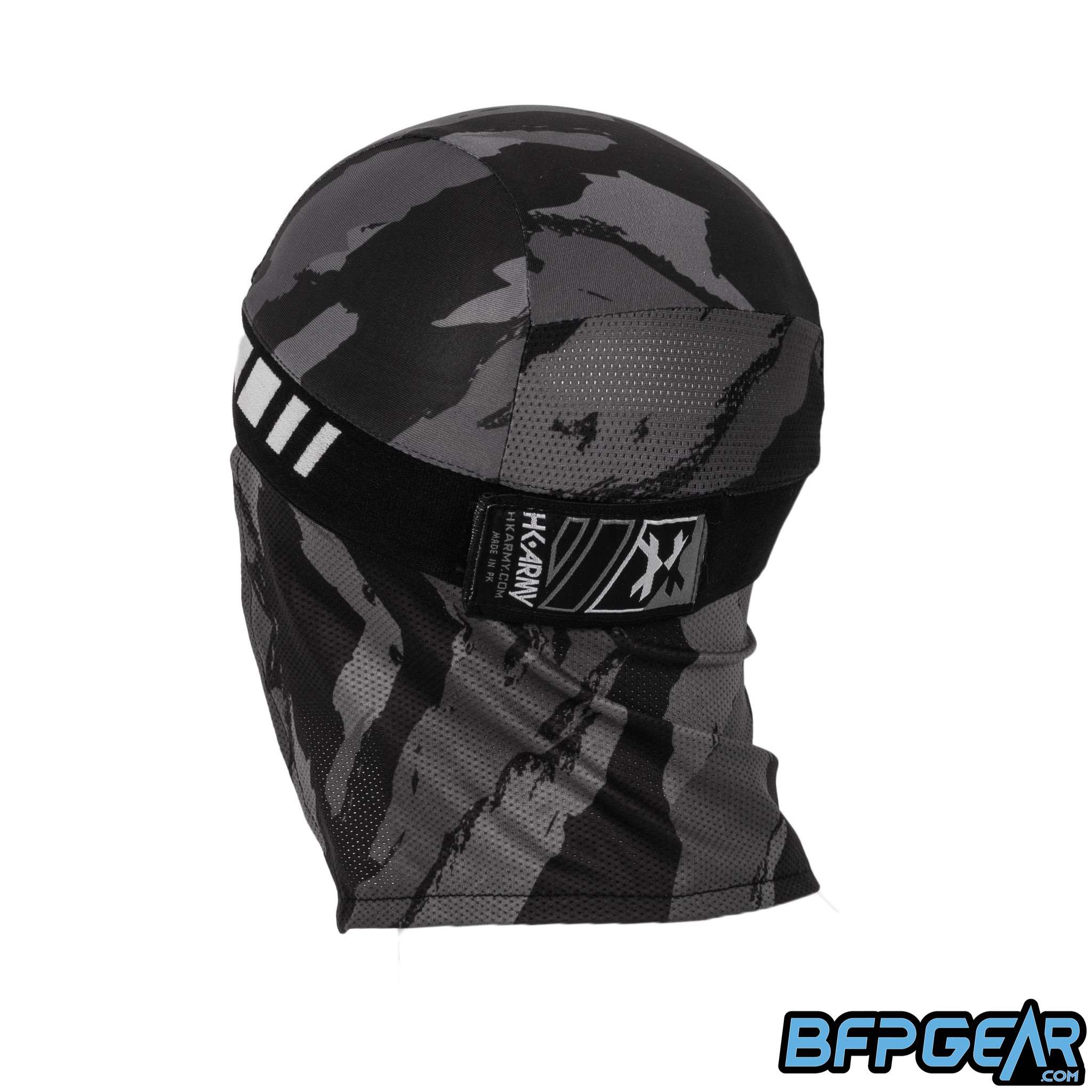 An angled view of the back of the skull cap in the Smoke color way. The elastic band secures firmly with velcro, and shows off an HK Army tag on the back. The mesh lining goes from the apex of the back of your head down over your neck for the best ventilation. The retro pattern goes all around the elastic band.