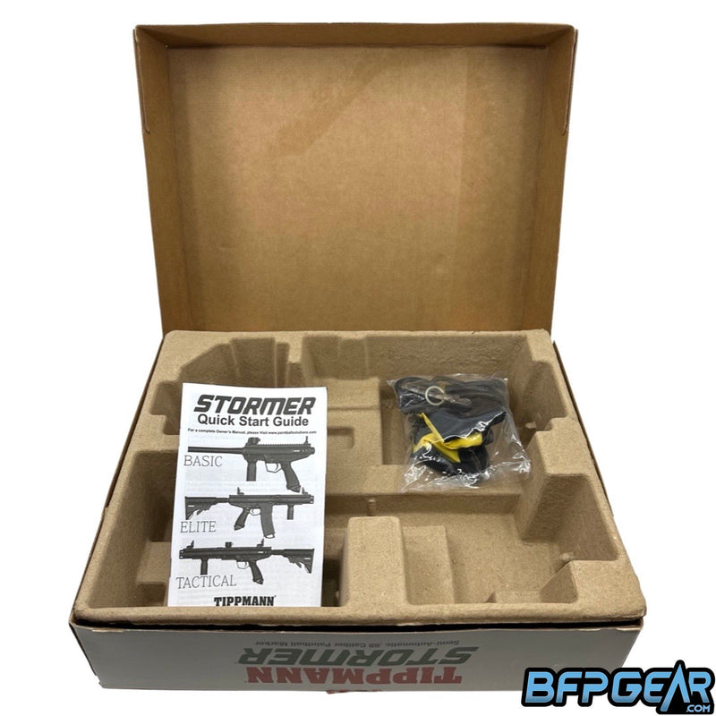 Tippmann Stormer packaging. Cardboard mold fits the marker and barrel easily. Included are spare parts, barrel squeegee, barrel sock, Allen keys, and a user manual.