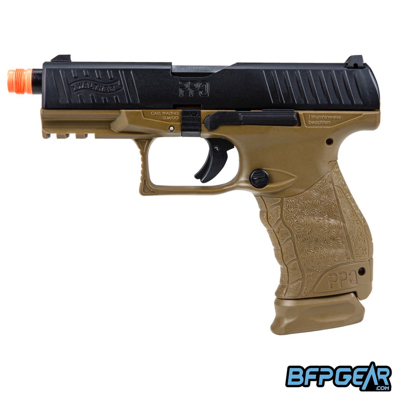 The Walther PPQ Tac gas blow back airsoft pistol in black and dark earth. Magazine eject button and slide check are on this side of the pistol.