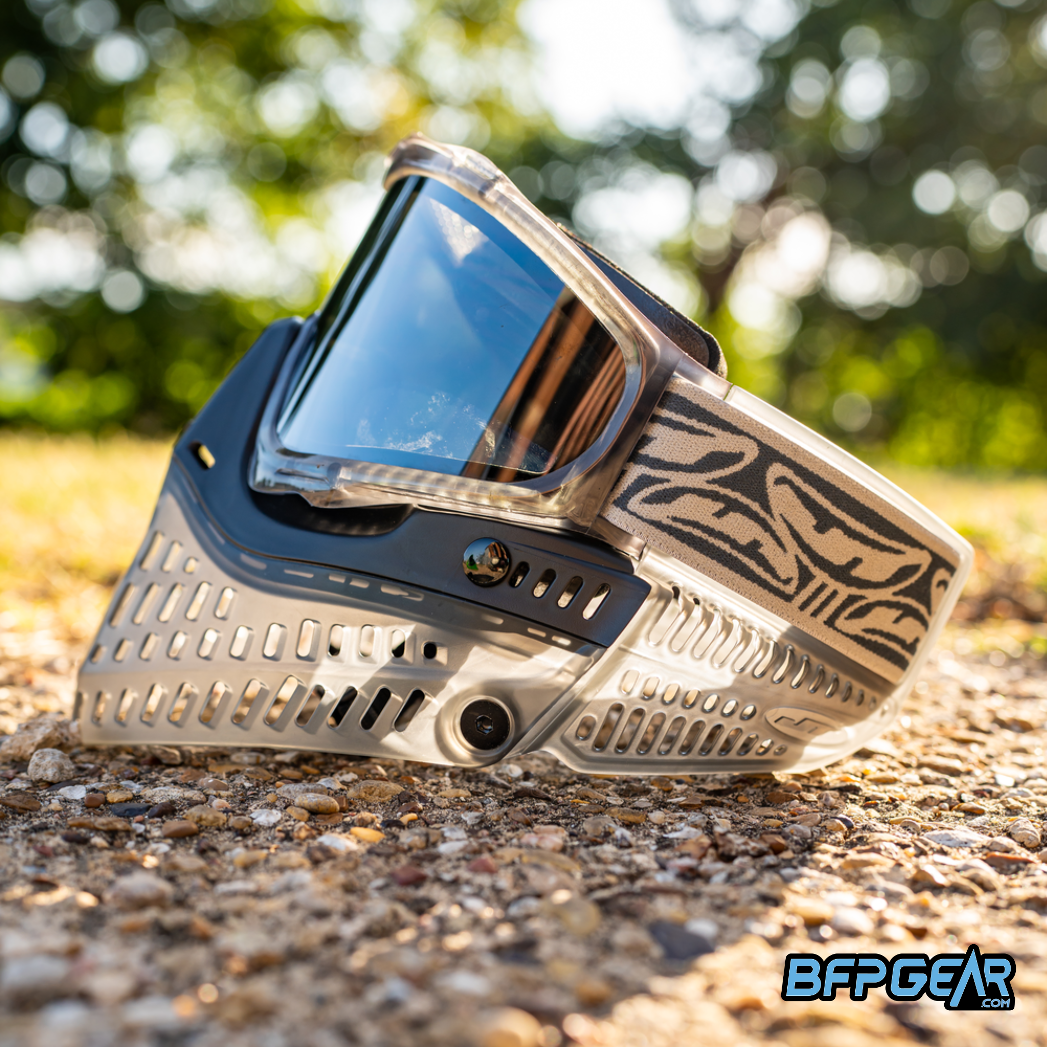 JT ProFlex LE ICE Stratus Smoke paintball goggle in outdoor sunlight showing translucent smoke frame vented lower and clear thermal lens