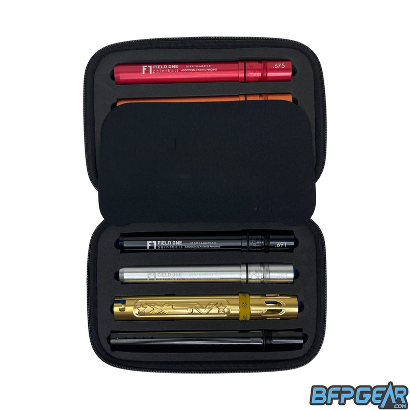 A picture of the XSV Acculock barrel in the protective case. A middle flap covers four of the inserts, and displayed are two inserts, gloss gold XSV barrel back, and a gloss black barrel tip.