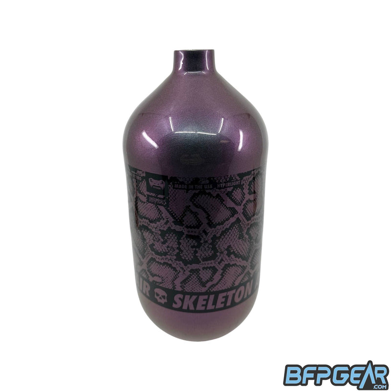 A photo of the Infamous 80ci Chameleon bottle with the Python pattern. Gloss purple with a green pearlescent and a printed snakeskin pattern. The bottom of the pattern says Skeleton Air with the Infamous skull on it. This tank does not come with a regulator, bottle only.
